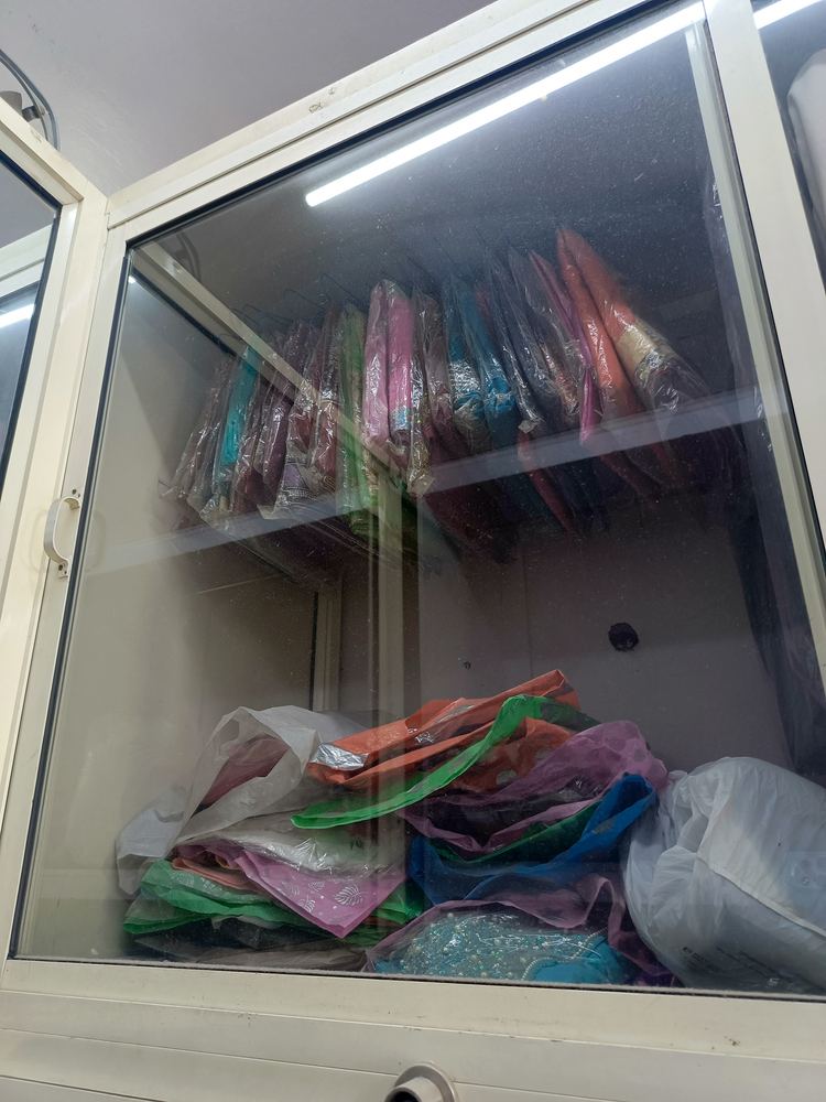 Sarees and suits packed in the shop cabinet after dry cleaning